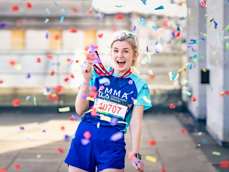 A supporter of Guy's Cancer smiles after running the London Marathon