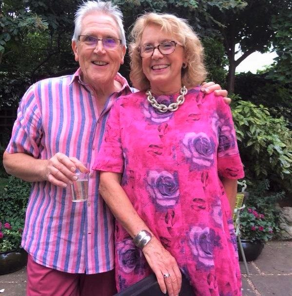 Ted in a pink and purple striped shirt and Susie in a pink floral dress