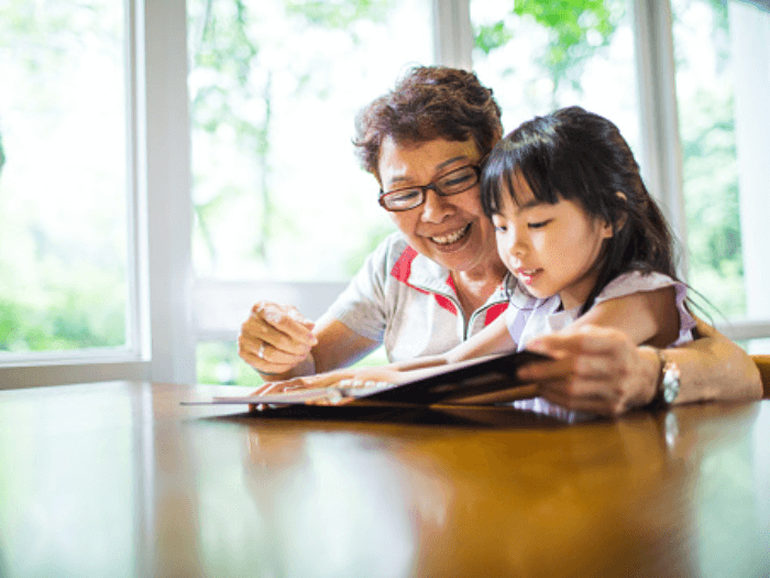 Grandmother and grandchild reading a book.