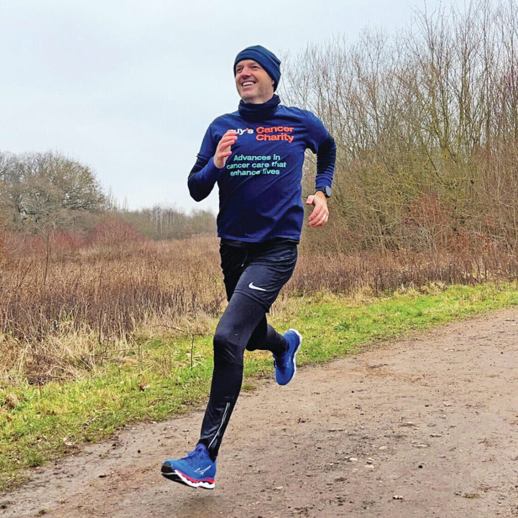 Gary captured mid running, wearing a navy t-shirt that reads 