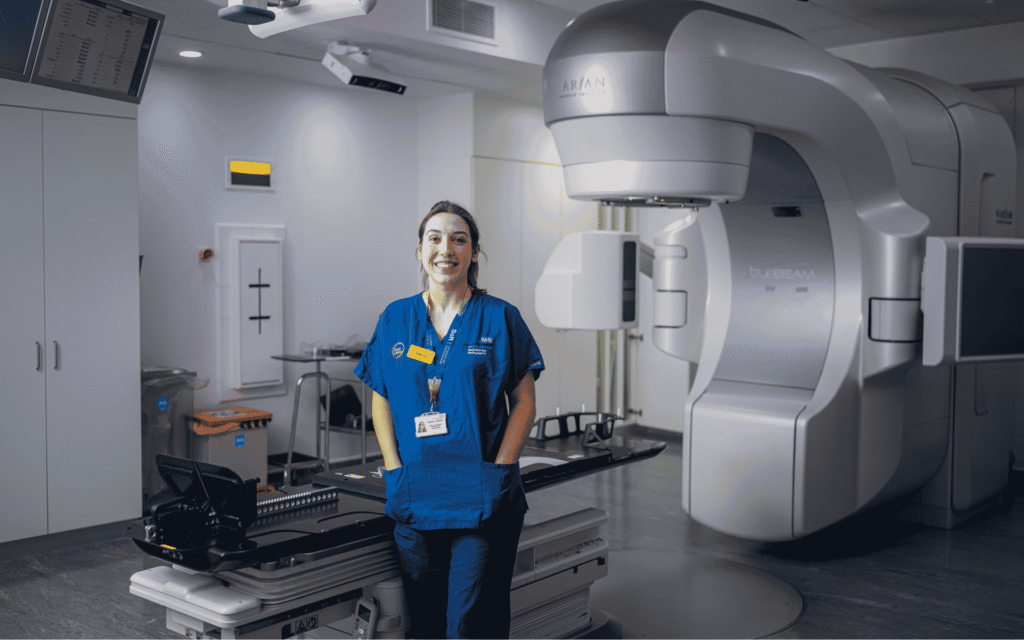 Nurse in front of the HyperArc machine she is in Guy