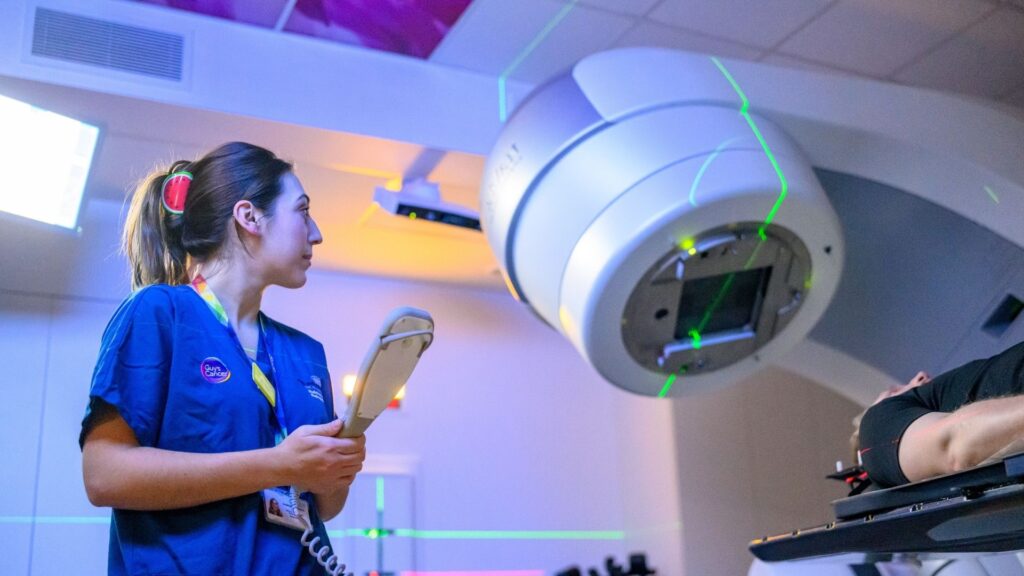 Nurse using the HyperArc machine she is in Guy