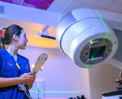 Nurse using the HyperArc machine she is in Guy