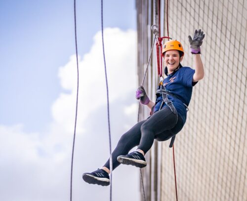 Woman abseiling down St Thomas