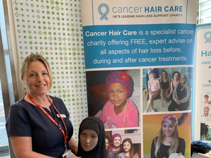 Woman holding a mannequin head that